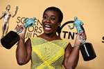Uzo Aduba poses in the press room with the awards for outstanding ensemble in a comedy series and outstanding female actor in a comedy series for 